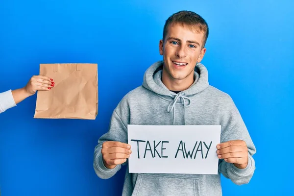 Young Caucasian Man Holding Take Away Banner Reciving Delivery Paper — стоковое фото