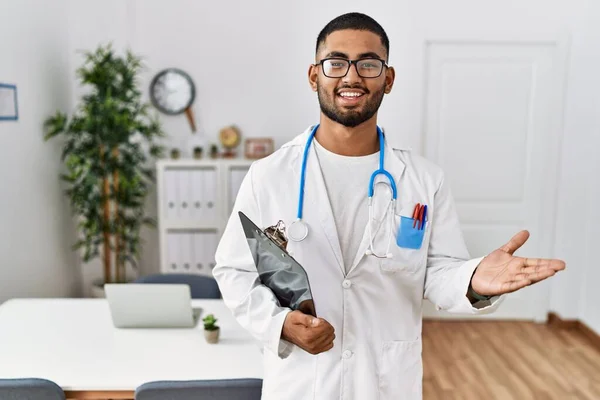 Young Indian Man Wearing Doctor Uniform Stethoscope Pointing Aside Hands — Stock Photo, Image
