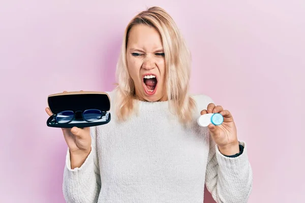 Beautiful Caucasian Blonde Woman Holding Glasses Contact Lenses Angry Mad — Fotografia de Stock