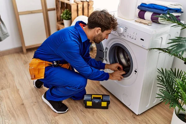 Jonge Spaanse Man Draagt Klusjesman Uniform Repareert Wasmachine Wasruimte — Stockfoto