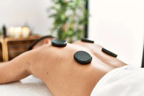 Young Hispanic Man Relaxed Having Back Massage Using Black Stones — Foto Stock