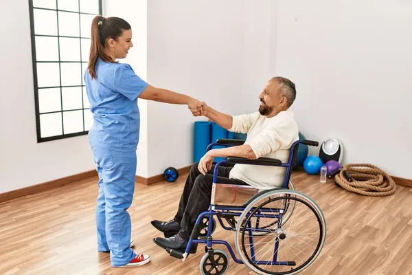 Ανώτερος Άνθρωπος Κάθεται Αναπηρική Καρέκλα Και Γηριατρική Νοσοκόμα Κάνει Χειραψία — Φωτογραφία Αρχείου