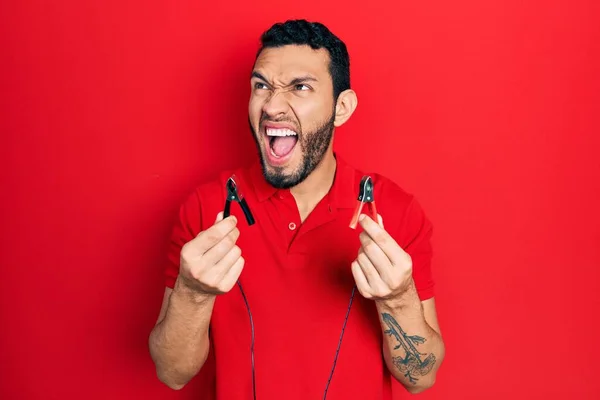 Hispanic Man Beard Holding Battery Clamps Angry Mad Screaming Frustrated — Stock Photo, Image