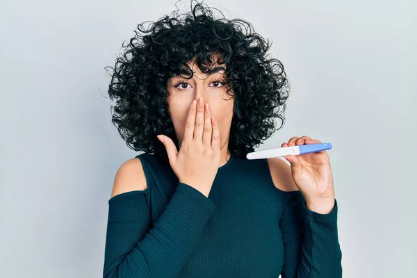 Young Middle East Woman Holding Pregnancy Test Result Covering Mouth — Foto Stock
