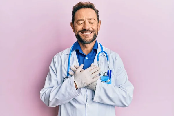 Middle Age Man Wearing Doctor Uniform Stethoscope Smiling Hands Chest — Stockfoto