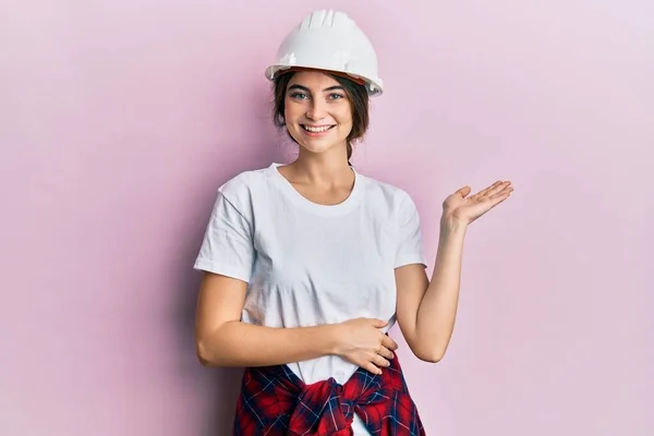 Young Caucasian Woman Wearing Hardhat Smiling Cheerful Presenting Pointing Palm — Stockfoto
