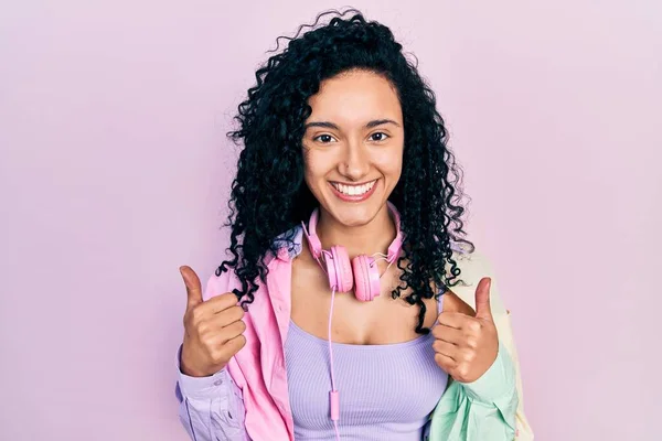 Young Hispanic Woman Curly Hair Wearing Gym Clothes Using Headphones — Stockfoto