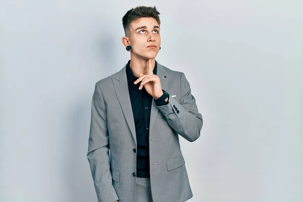 Young Caucasian Boy Ears Dilation Wearing Business Jacket Thinking Concentrated — Stock Photo, Image