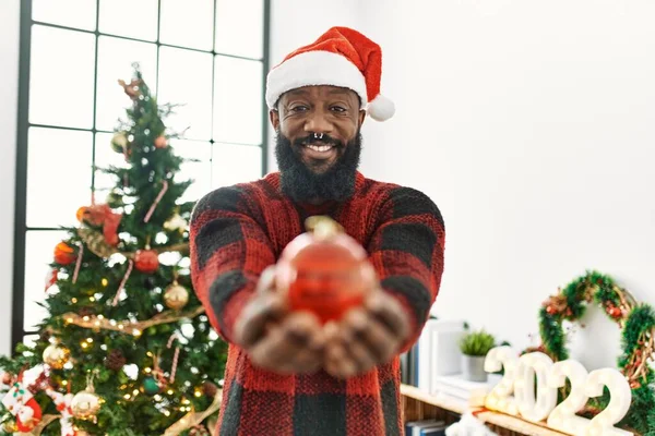 Young African American Man Smiling Confident Holding Ball Standing Christmas — стоковое фото