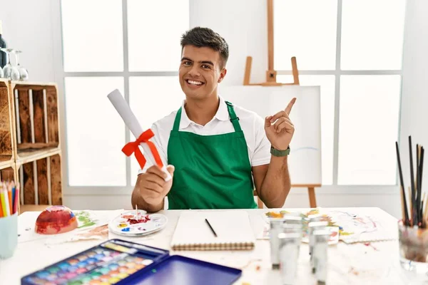 Young Hispanic Man Art Studio Holding Degree Big Smile Face — стоковое фото