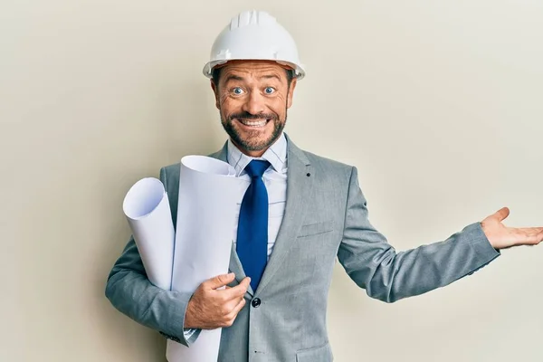 Middle Age Architect Man Wearing Safety Helmet Holding Blueprints Celebrating — Stockfoto