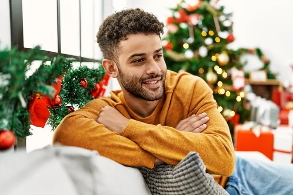 Young Arab Man Smiling Happy Sitting Sofa Christmas Tree Home — Zdjęcie stockowe