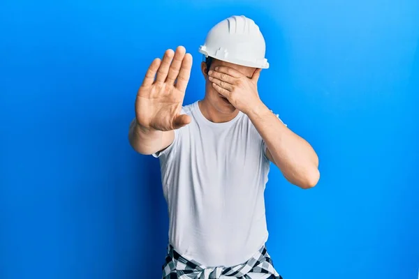 Handsome Young Man Wearing Builder Uniform Hardhat Covering Eyes Hands — Φωτογραφία Αρχείου