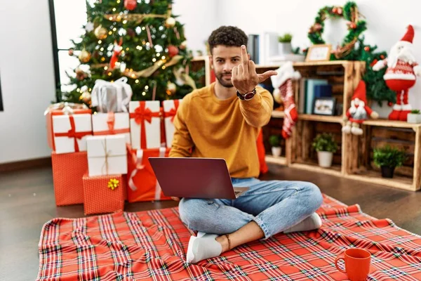 Arab Young Man Using Laptop Sitting Christmas Tree Showing Middle — 图库照片