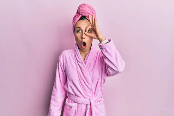 若いブロンドの女性がシャワータオルキャップとバスローブを着用し 驚きの顔でショックを受けたOkジェスチャーを行うと 目を指で見て 信じられない表現 — ストック写真