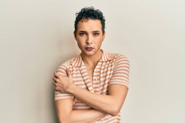Handsome man wearing make up wearing casual shirt looking positive and happy standing and smiling with a confident smile showing teeth 