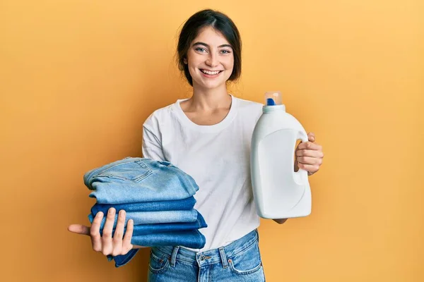 Young Caucasian Woman Doing Laundry Holding Detergent Bottle Folded Jeans — 图库照片