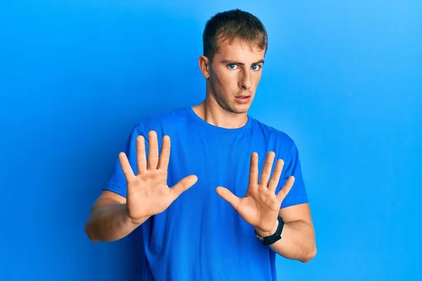 Young Caucasian Man Wearing Casual Blue Shirt Moving Away Hands — стоковое фото