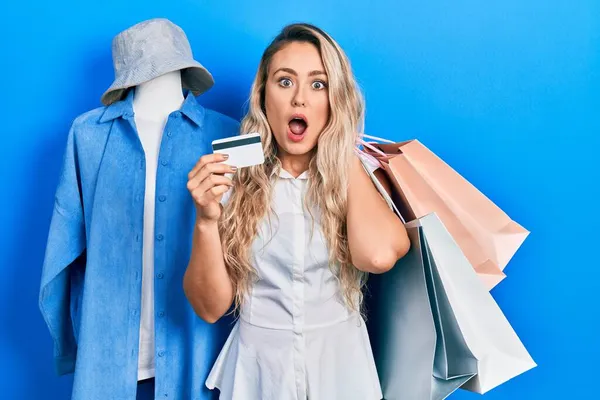 쇼핑백 카드를 아름다운 금발의 여성은 놀라고 표정으로 두려움 흥분된 얼굴로 — 스톡 사진