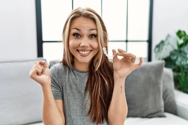Young Caucasian Woman Holding Invisible Aligner Orthodontic Screaming Proud Celebrating — 스톡 사진