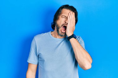 Orta yaşlı, günlük kıyafetler giyen, yarı yüz, göz ve ağız kaplamasından yorgun düşmüş beyaz bir adam. Yüzüm acıyor.. 