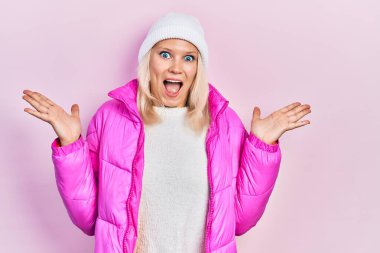 Yün şapka ve kışlık palto giyen güzel beyaz kadın çılgın kutlamalar yapıyor ve kollarını kaldırıp heyecanla haykırarak başarıyı hayrete düşürüyor. Kazanan konsept 