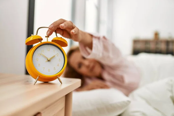 Middle Age Caucasian Woman Turning Alarm Clock Lying Bed Bedroom — Fotografia de Stock