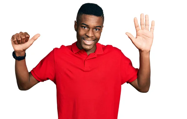 Young African American Man Wearing Casual Red Shirt Showing Pointing — Stockfoto