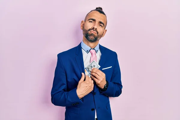 Young Hispanic Man Wearing Business Suit Holding Dollar Looking Camera — Stockfoto