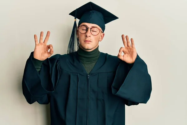 Young Caucasian Man Wearing Graduation Cap Ceremony Robe Relax Smiling — стоковое фото