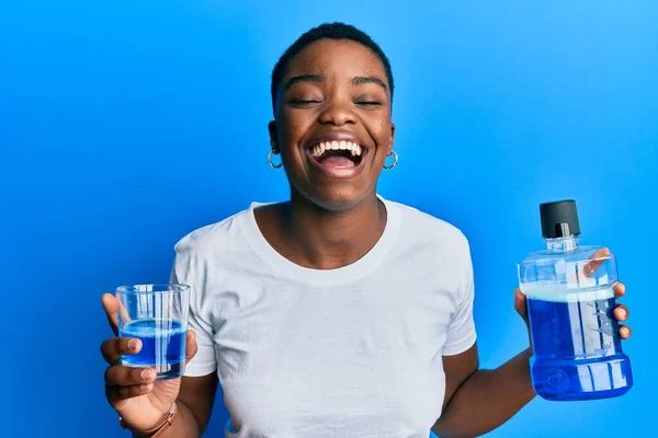 Young African American Woman Holding Mouthwash Fresh Breath Smiling Laughing — стоковое фото