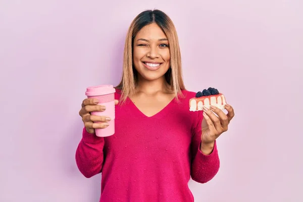 Beautiful Hispanic Woman Holding Takeaway Cup Coffee Cheesecake Winking Looking — Stock Photo, Image