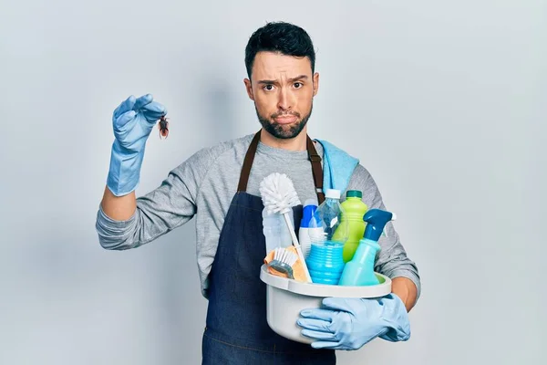 Young Hispanic Man Holding Cleaning Products Cockroach Depressed Worry Distress — Stockfoto