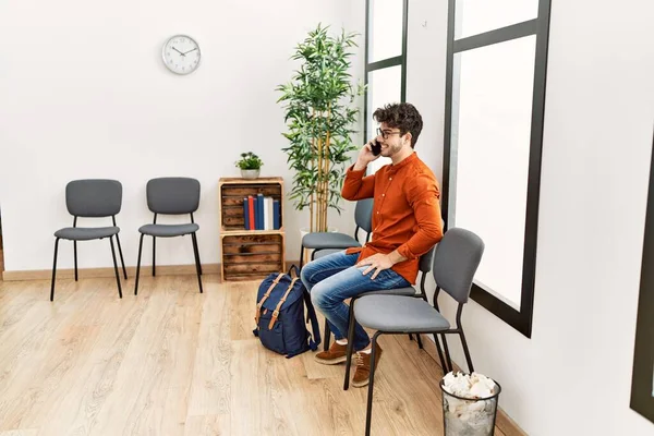 Young Hispanic Man Smiling Confident Talking Smartphone Waiting Room — Stockfoto