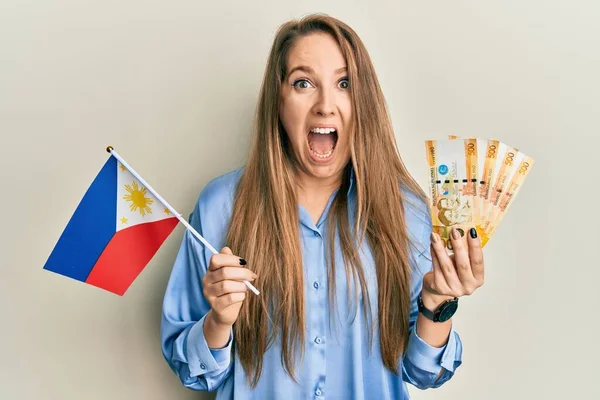 Young Blonde Woman Holding Philippine Flag Philippines Pesos Banknotes Celebrating — Stock Photo, Image