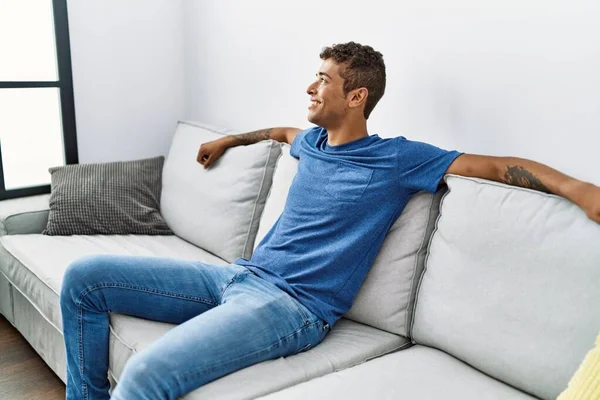 Young Hispanic Man Relaxing Sitting Sofa Home — Fotografia de Stock