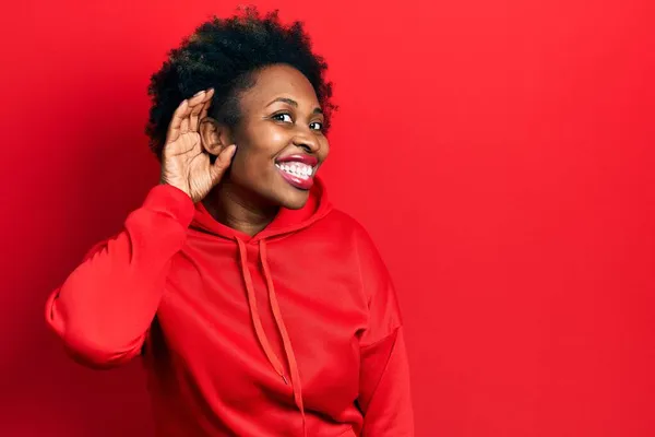 年轻的非洲裔美国女人穿着休闲装 面带微笑 两手相对地听着流言或流言蜚语 聋的概念 — 图库照片