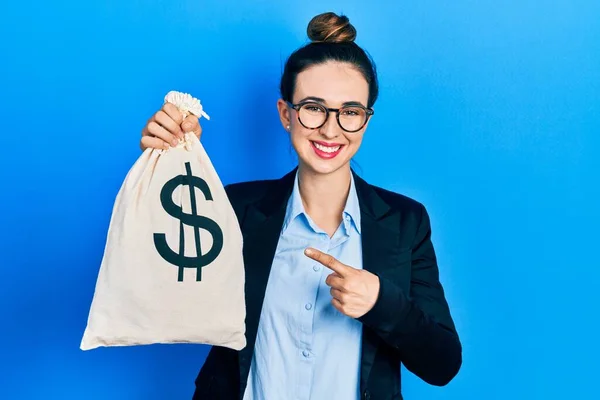 Young Hispanic Girl Wearing Business Clothes Holding Dollars Bag Smiling — Fotografia de Stock
