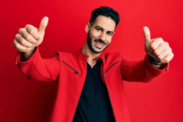 Young Hispanic Man Wearing Red Leather Jacket Approving Doing Positive — 图库照片