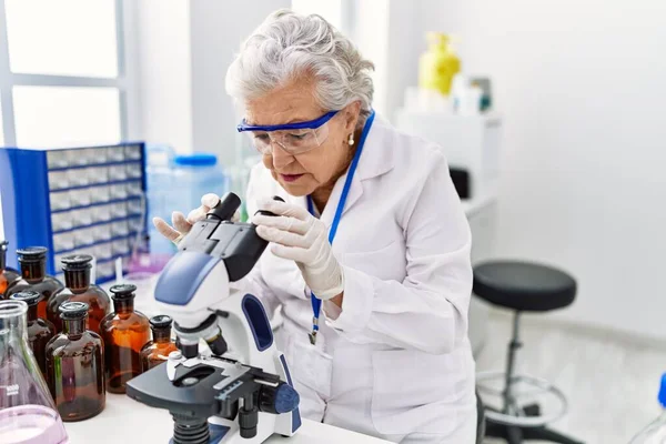 Ältere Grauhaarige Frau Wissenschaftleruniform Unter Dem Mikroskop Labor — Stockfoto