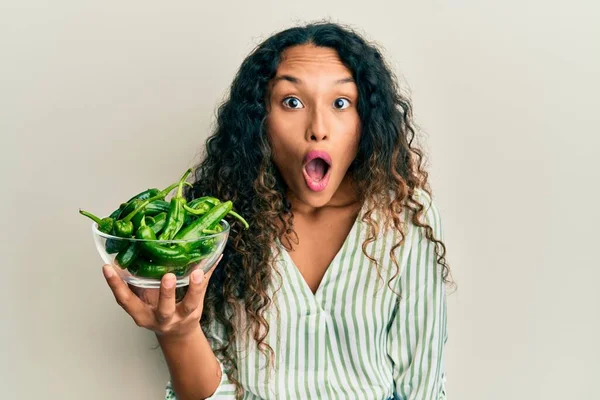 Young Latin Woman Holding Bowl Green Peppers Scared Amazed Open — Stock Photo, Image