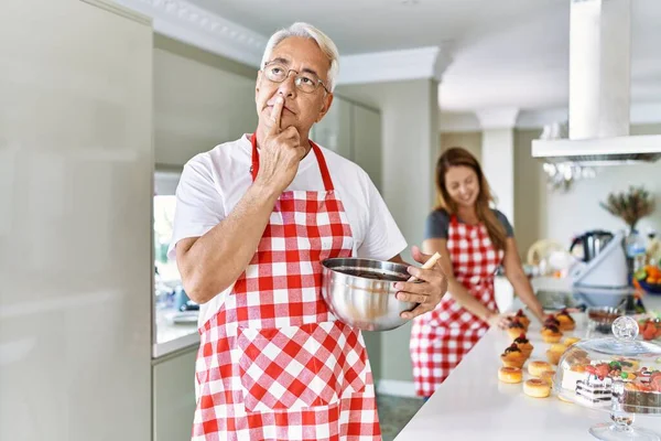 Middle Age Hispanic Couple Wearing Apron Cooking Homemade Pastry Serious — Φωτογραφία Αρχείου