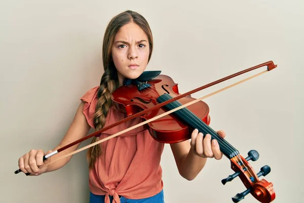 Beautiful Brunette Little Girl Playing Violin Skeptic Nervous Frowning Upset — Stock Photo, Image