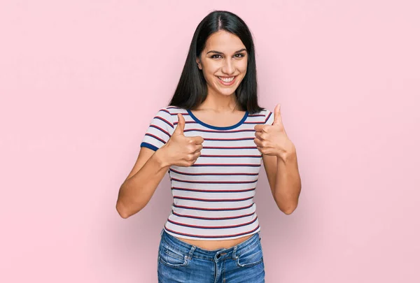 Young Hispanic Girl Wearing Casual Striped Shirt Success Sign Doing — 图库照片