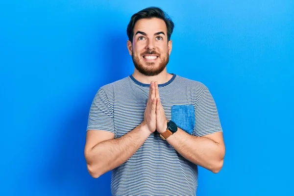 Handsome Caucasian Man Beard Wearing Casual Striped Shirt Praying Hands — Stockfoto