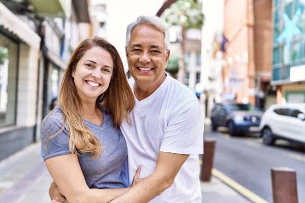 屋外で晴れた日に夫と妻の中年のパニックカップル 街で抱きかかえる愛に笑顔幸せ — ストック写真