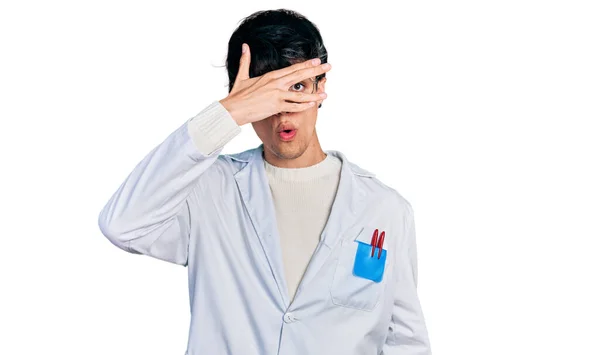 Handsome Hipster Young Man Wearing Doctor Uniform Peeking Shock Covering — Stockfoto