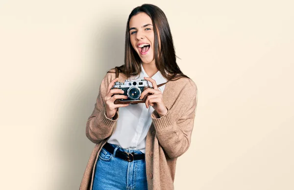 Young Brunette Teenager Holding Vintage Camera Smiling Laughing Hard Out — Foto Stock