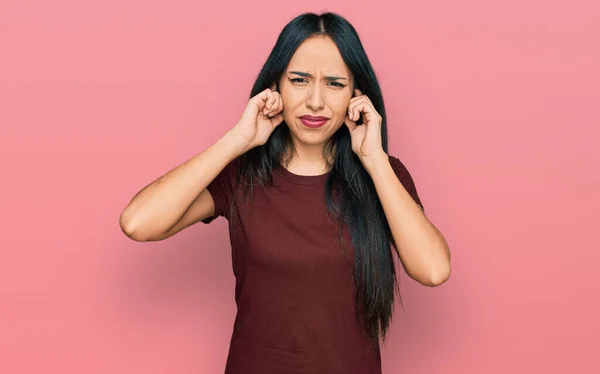 Young Hispanic Girl Wearing Casual Shirt Covering Ears Fingers Annoyed — Stockfoto