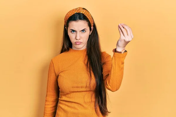 Young Brunette Teenager Wearing Casual Yellow Sweater Doing Italian Gesture — 图库照片